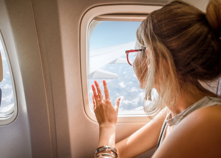 woman looking out of plane window