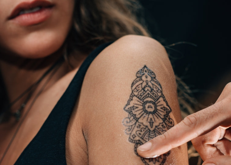 tattoo on sleeve of arm black ink on woman