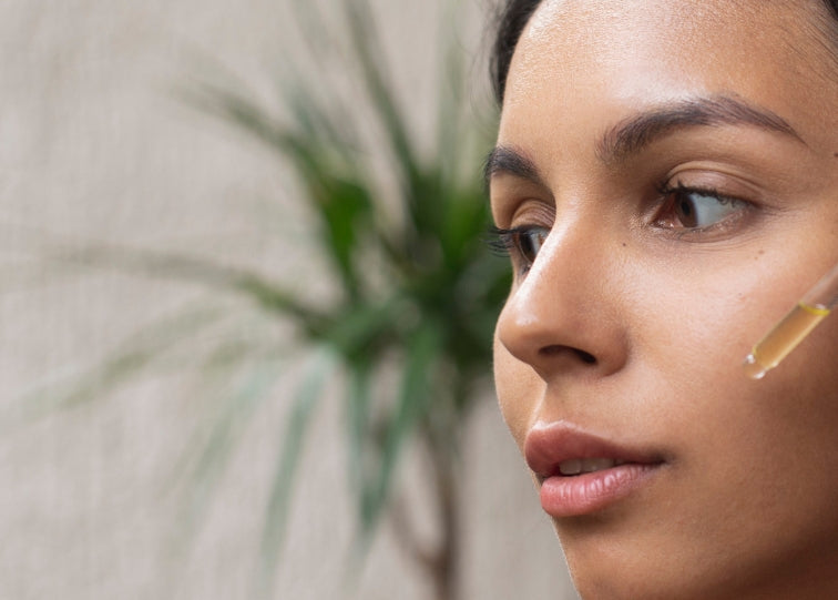 women putting on serum